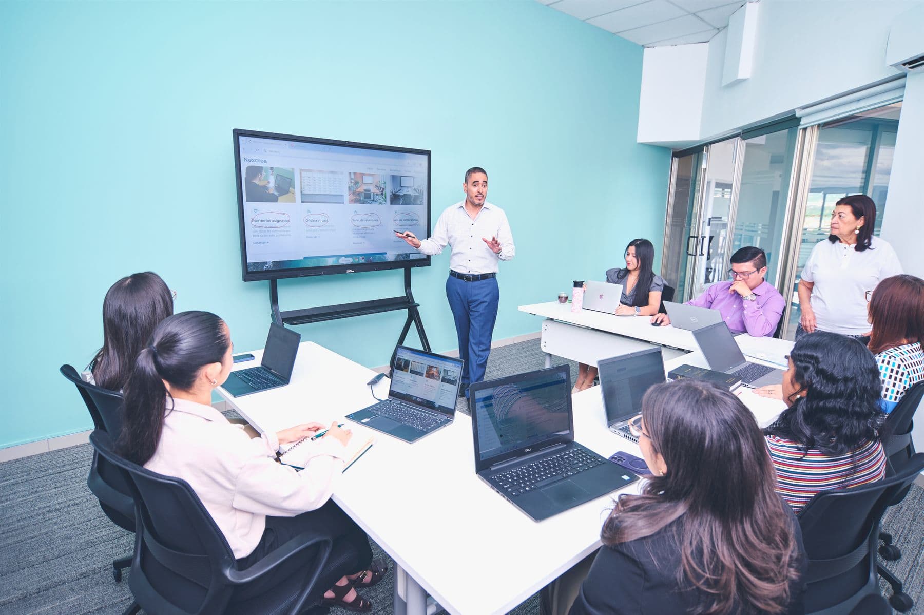 Research team reviewing a live product walkthrough together in a modern office
